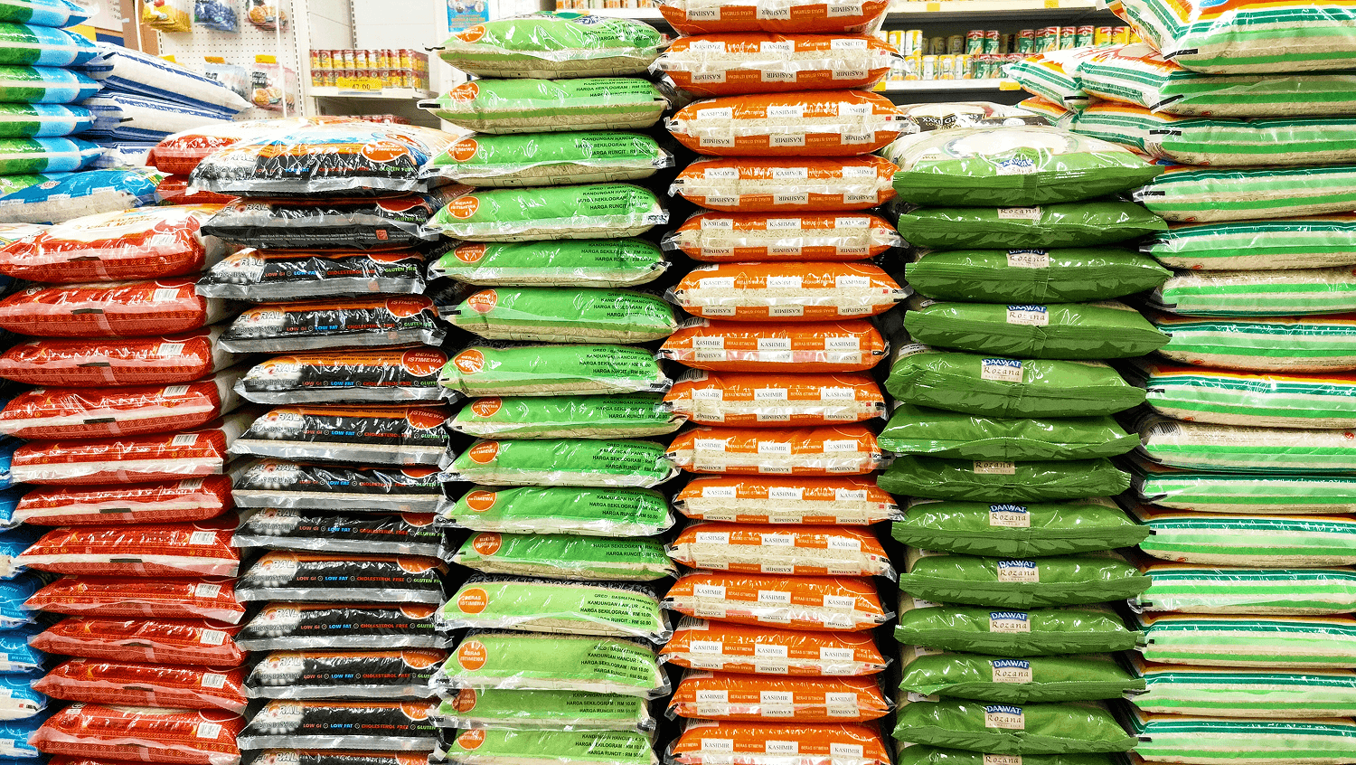 supermarket shelves displaying multiple brands of packaged rice in food-grade flexible packaging