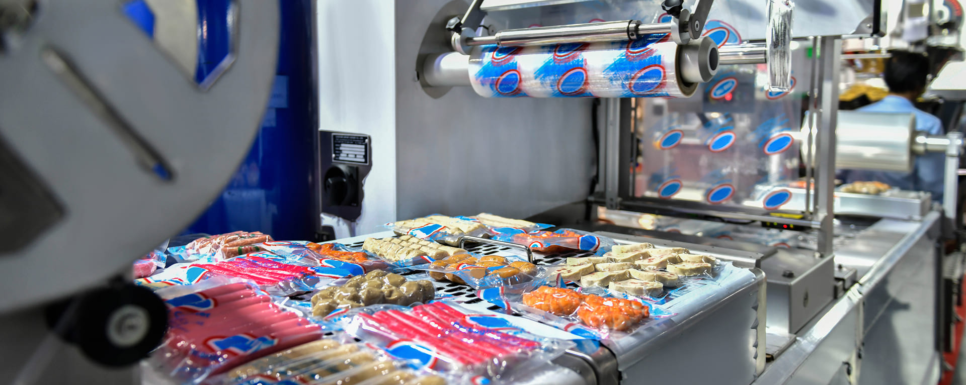 Industrial food packaging line sealing sausages and snack products in plastic packaging for the food industry in Malaysia